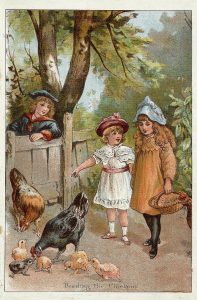 two little girls feeding chickens